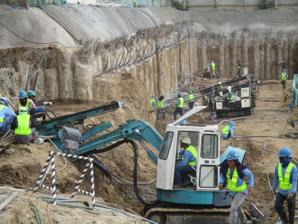 MEGA Philippines crew operating drilling equipment for slope protection at the Central Bloc construction site